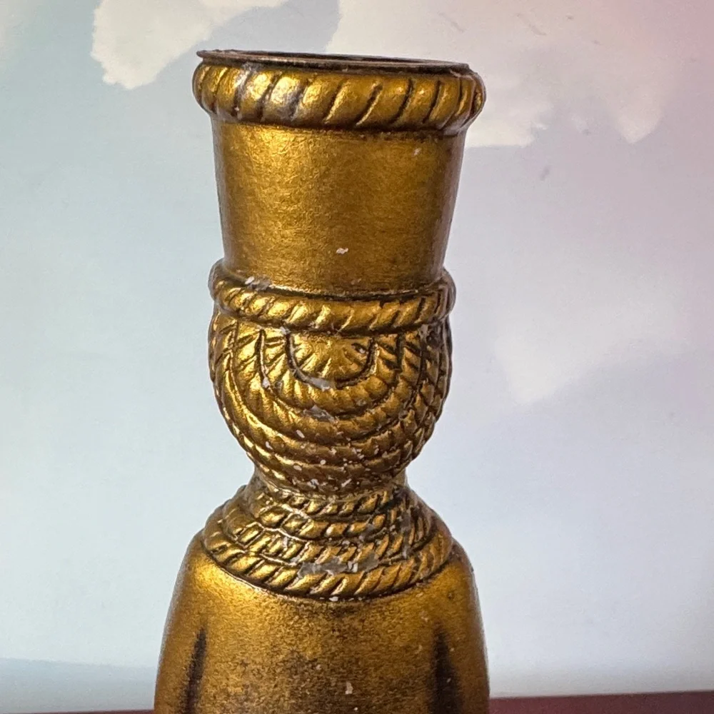 vintage chalkware candle holder featuring a metallic gold-finished figure